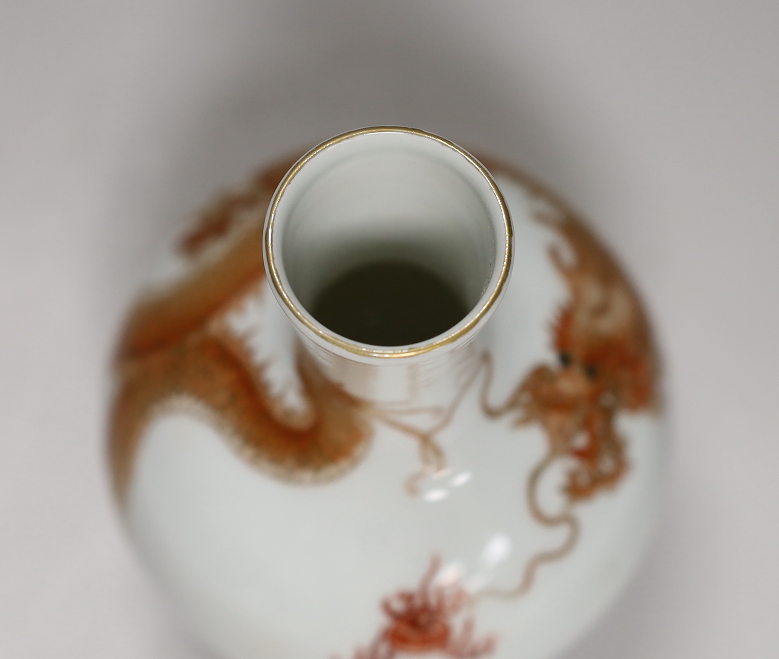 A Chinese rouge de fer decorated ‘dragon’ bottle vase, 14cm high (boxed)